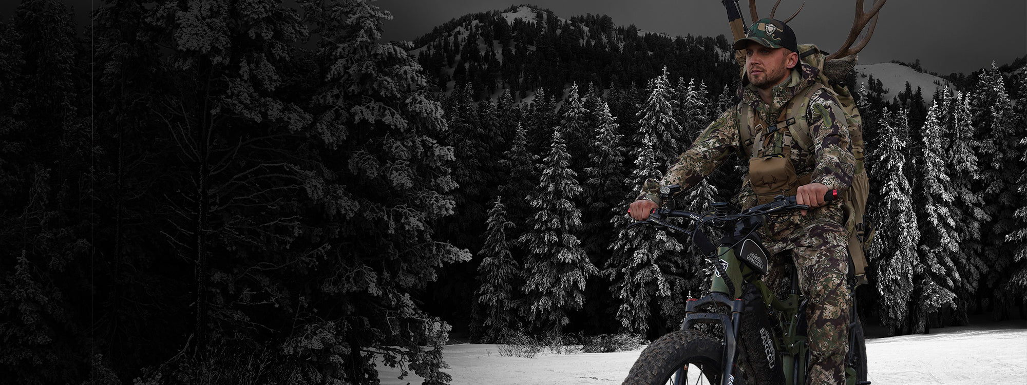 Hunter on an eBike with antlers in his pack on a snowy day surrounded by pine trees