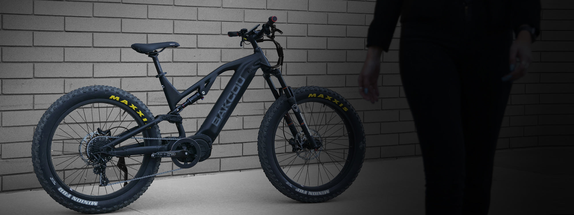 Bakcou Scout full suspension eBike black leaning up against a wall